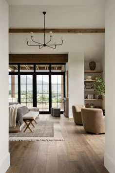 a living room filled with furniture and a large window