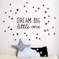 a wall decal that says dream big little one with stars on it and a stuffed animal