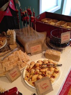 a table topped with lots of desserts and snacks on top of a white plate