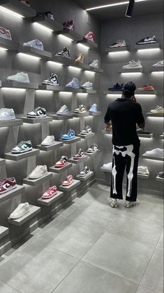 a man standing in front of a display of shoes