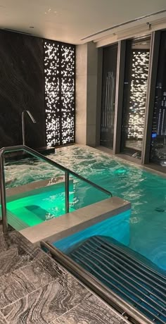 an indoor swimming pool in the middle of a building