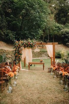 an outdoor ceremony set up with flowers and greenery