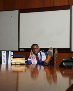 a man sitting at a table with his feet up