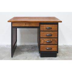 a wooden desk with three drawers on it