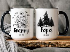 two coffee mugs sitting on top of a wooden table