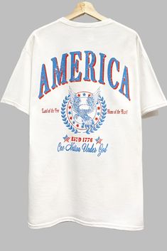 America Graphic T Shirt Americana Graphic Tee, Americana Cotton T-shirt With Letter Print, Oversized Crew Neck Tops For 4th Of July, Oversized Casual Tops For 4th Of July, Casual Oversized Tops For 4th Of July, White Americana T-shirt For 4th Of July, White Americana Letter Print T-shirt, Retro American Flag Print Summer T-shirt, American Retro Short Sleeve Cotton T-shirt