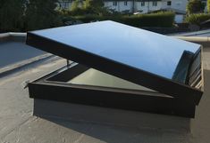 an open metal box sitting on top of a roof