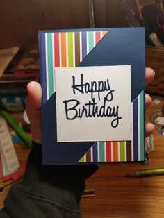 a person holding up a birthday card with the words happy birthday on it