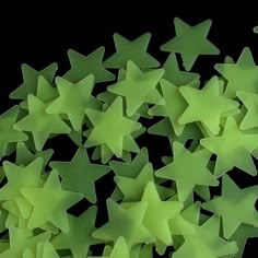 a large group of green stars on a black background