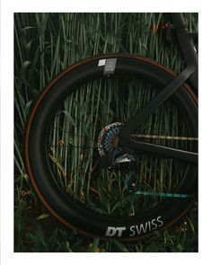 a close up of a bike tire in the grass