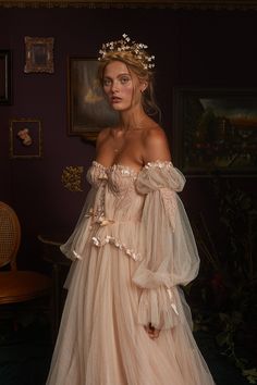 a woman in a wedding dress is posing for the camera with her hands on her hips