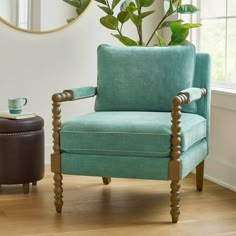 a living room with a blue chair and potted plant