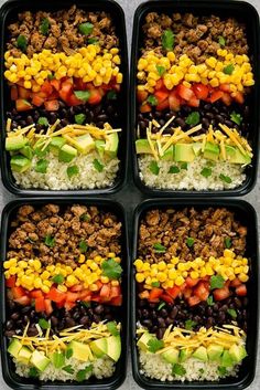 four black trays filled with different types of food and veggies on top of rice