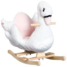 a white stuffed bird sitting on top of a wooden rocking toy