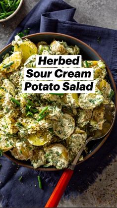 a bowl filled with potato salad next to green beans and parsley on a blue towel