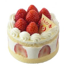 a cake with white frosting and strawberries on top is shown in front of a white background