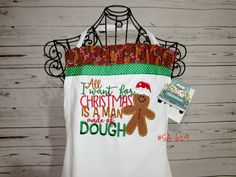 a white shirt with a gingerbread man on it and a christmas decoration hanging from the front