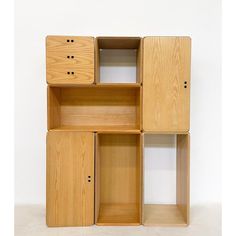 a wooden shelf with three drawers and two doors