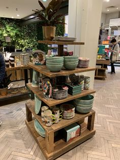 there are many plates and bowls on the shelves