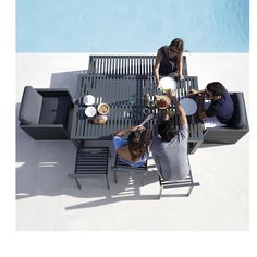 three people sitting at a table with plates of food