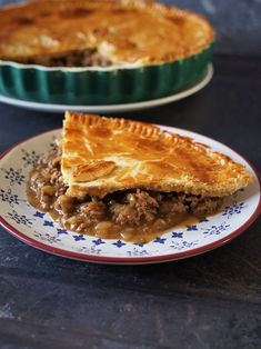 two plates with pies on them sitting on a table