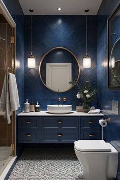 a bathroom with blue walls and gold accents