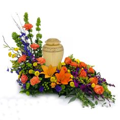 an arrangement of flowers and a vase on a white background