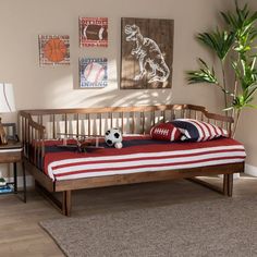 a bedroom with a wooden bed and soccer themed decor on the wall, along with a potted plant