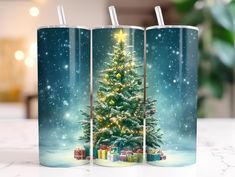 three coffee mugs with a christmas tree on them