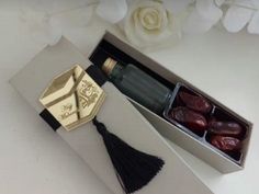 an open box with some chocolates in it and a tassel on the side