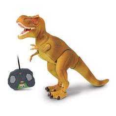 a toy t - rex is next to a remote control device on a white background