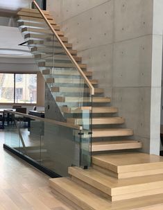 a staircase with glass railing and wooden steps