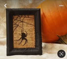 an image of a spider on a page in a frame with a pumpkin behind it