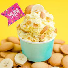 an ice cream sundae with banana slices and other desserts around it on a yellow background