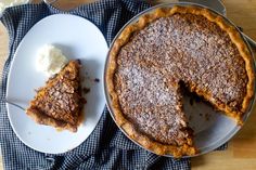 there is a pie on the table with a piece missing from it and another plate next to it