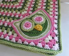 a crocheted blanket is laying on the table