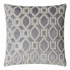 a grey and white pillow with diamonds on it