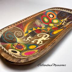 a decorative wooden tray with colorful designs on it