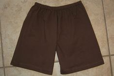 a pair of brown shorts sitting on top of a tile floor