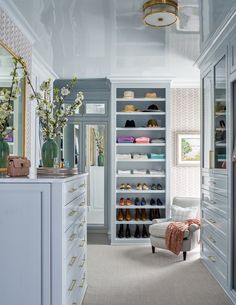 a walk in closet filled with lots of white furniture and shoes on top of shelves