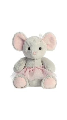 a stuffed animal that is wearing a pink tutule and sitting on the ground