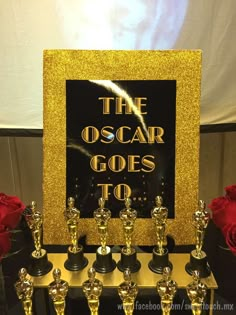 the oscar awards are lined up in front of a sign that reads,'the oscar goes to '