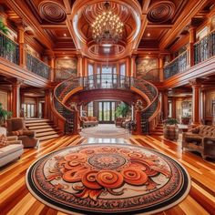 a large living room with wooden floors and chandeliers on the ceiling, along with an ornate staircase