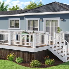 a small blue house with white railings and windows