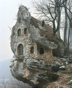 an old stone house built into the side of a cliff