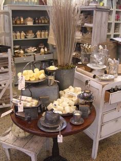 an assortment of cheeses on display in a store with lots of other items behind it