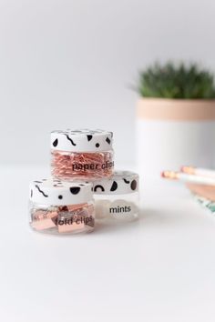 three rolls of washi tape sitting on top of each other next to a potted plant