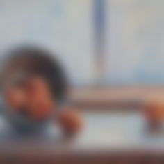 blurry photograph of a child's head and hands behind a table top with an open window in the background