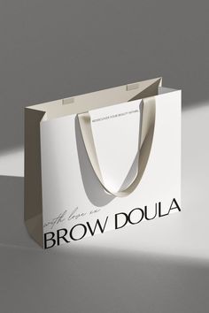 a brown and white bag with the words brow doula on it's side