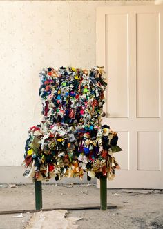 a chair made out of many different types of papers on it's back legs